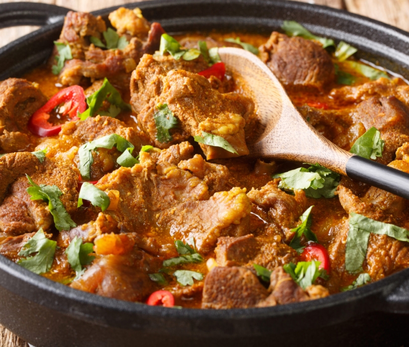 Indian traditional food Lamb rogan josh close-up in a pan on the table. horizontal